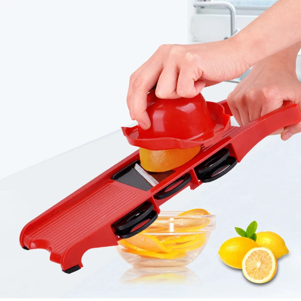 coupe-fruits multifonctionnel en acier  l'appareil seul sans réservoir avec une main qui tiens la securité  et qui coupe une orange 